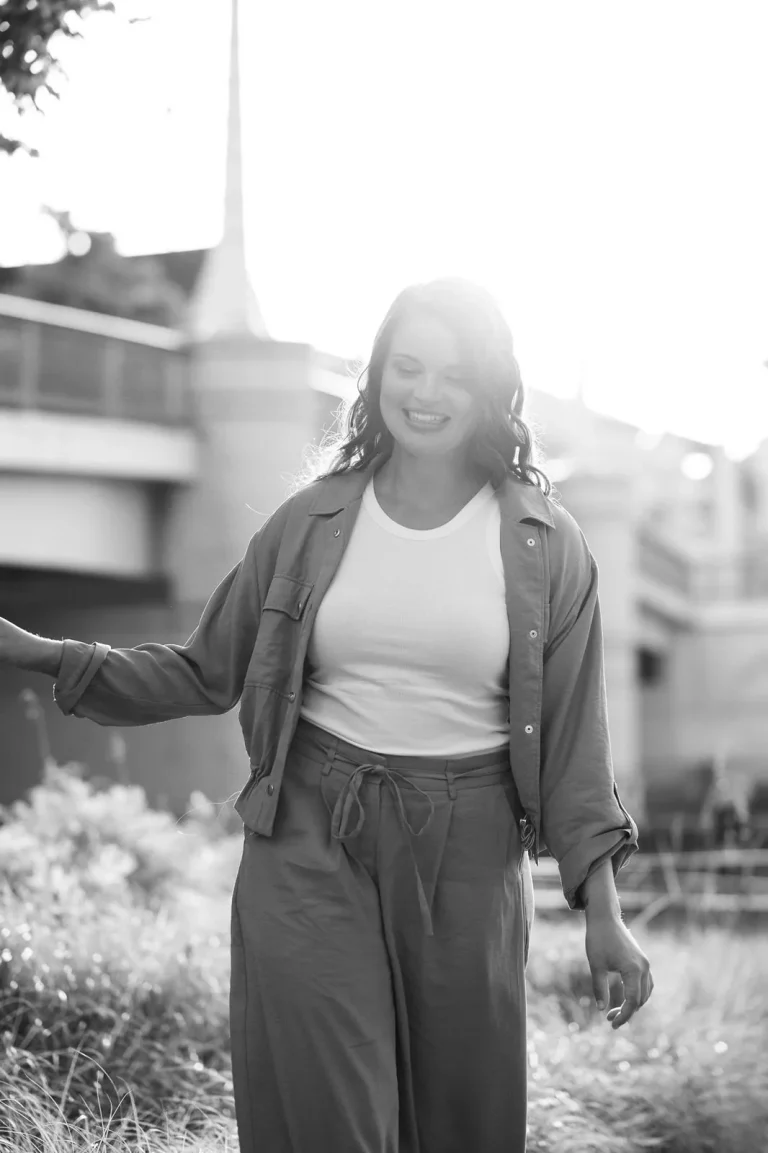 Smiling woman walking outdoors in sunlight