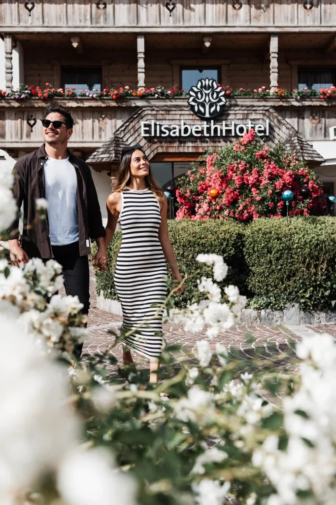 Paar vor ElisabethHotel mit Blumen im Vordergrund